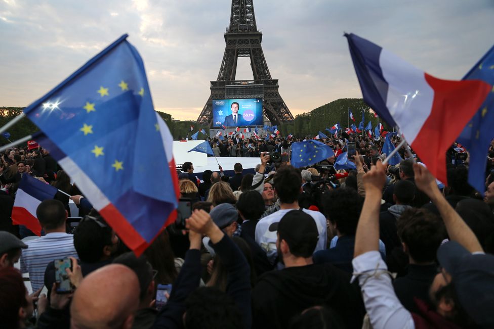 Supporters of French President Emmanuel Macron celebrate his presidential election victory, at the foot of the Eiffel Tower in Paris on 24 April 2022