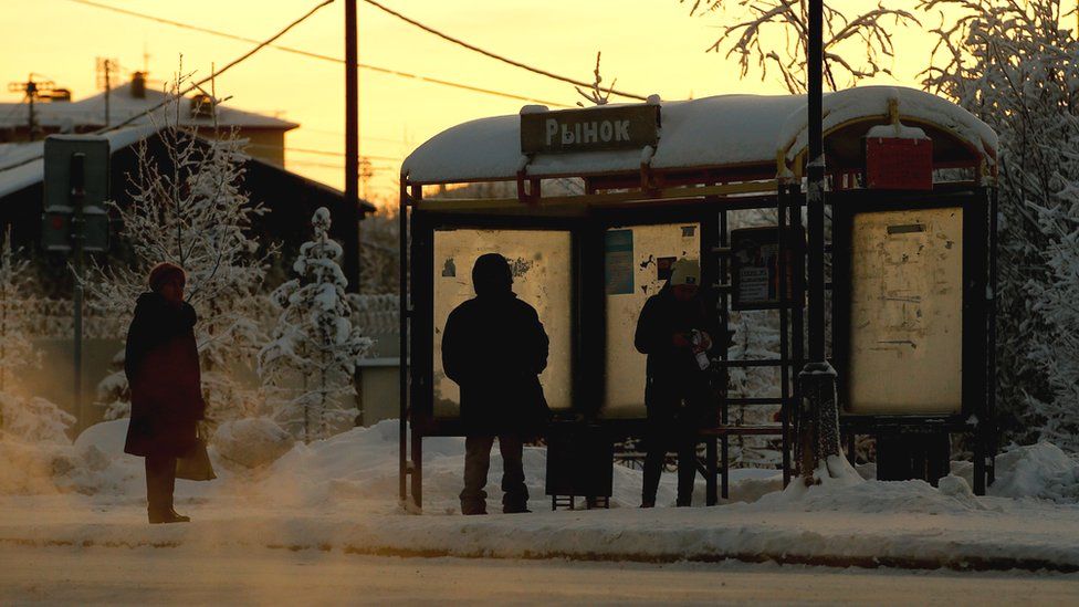 People wait in freezing temperatures at a bus stop in Salekhard, a city in Russia's Yamalo-Nenets Autonomous Area.
