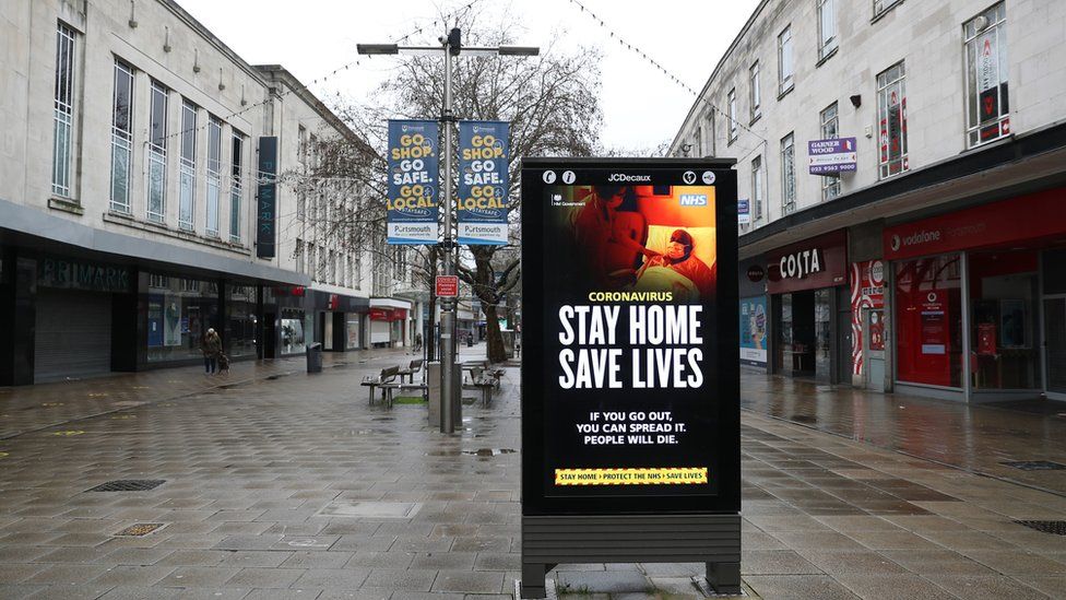 A "Stay Home Save Lives" government sign on Commercial road in Portsmouth