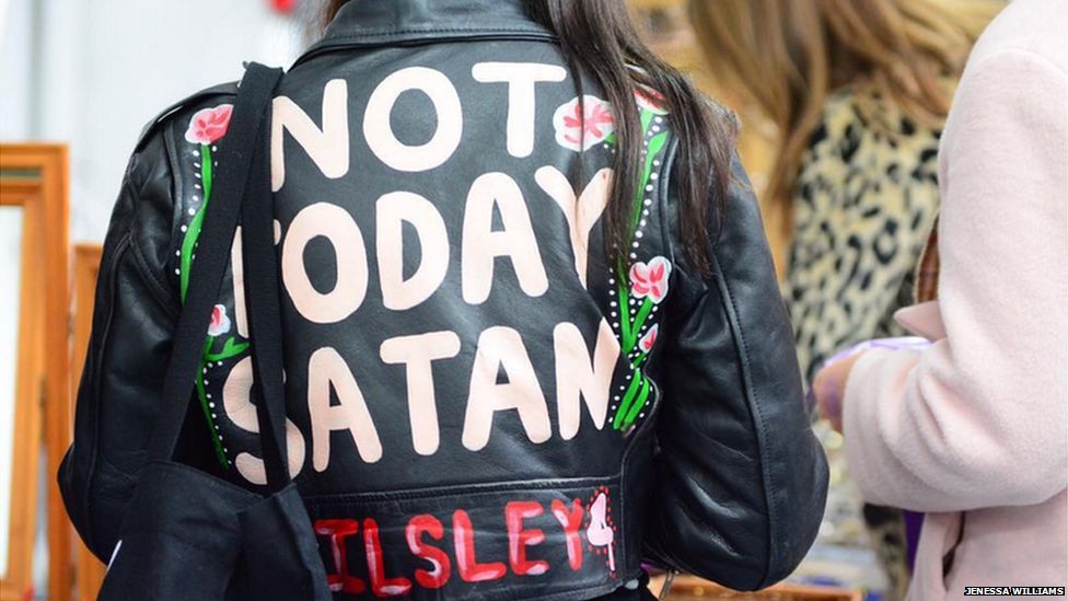 Designer and artist Elizabeth Ilsley wearing a leather jacket which has written on it "Not today Satan"