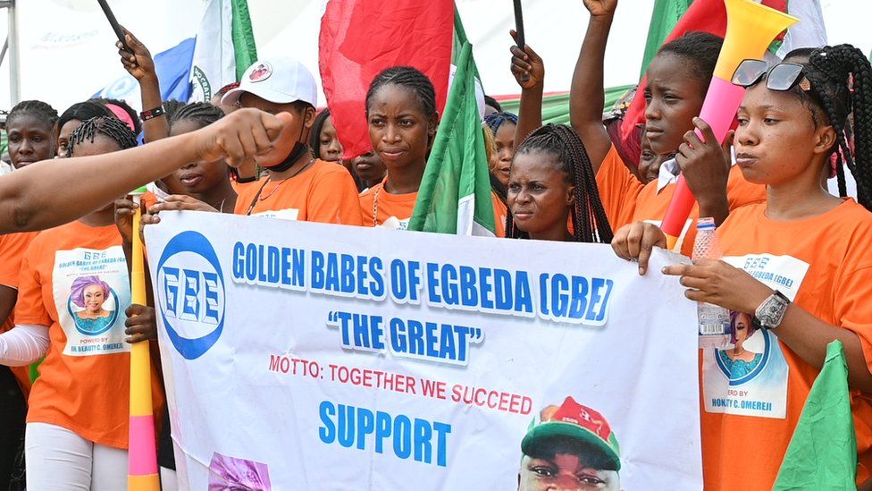Women in orange clothes holding a banner a rally in Rivers state, Nigeria