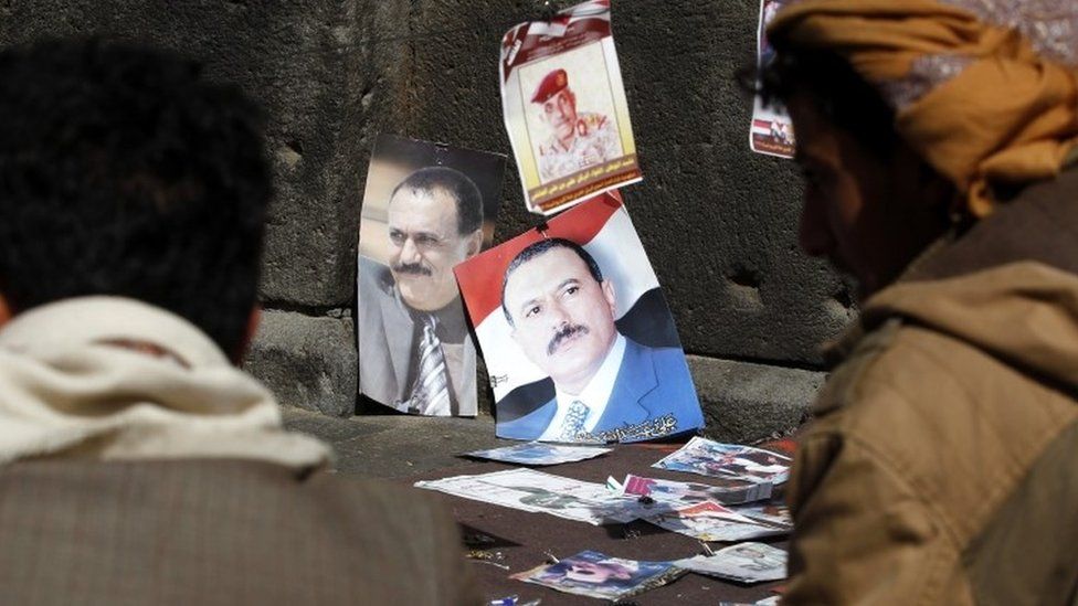 Posters of former Yemeni president Ali Abdullah Saleh are displayed for sale on the sixth anniversary of the 2011 Arab Spring