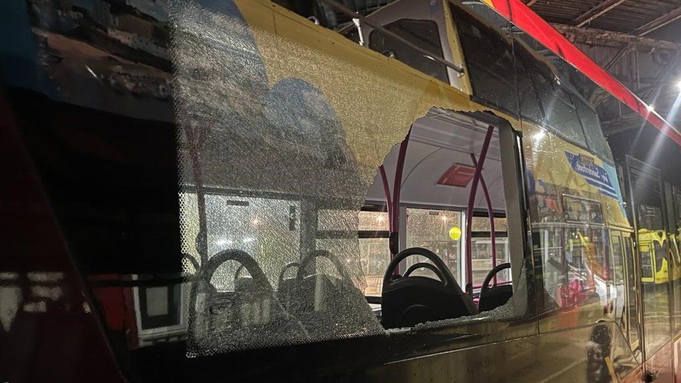 Service 111 bus in Wales with a shattered window