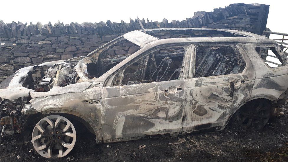 A burned-out Land Rover Discovery
