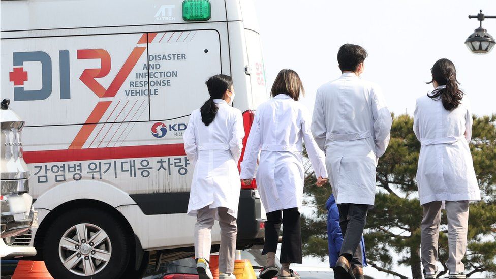 Medical workers walk at a general hospital in Seoul, South Korea, 13 February 2024