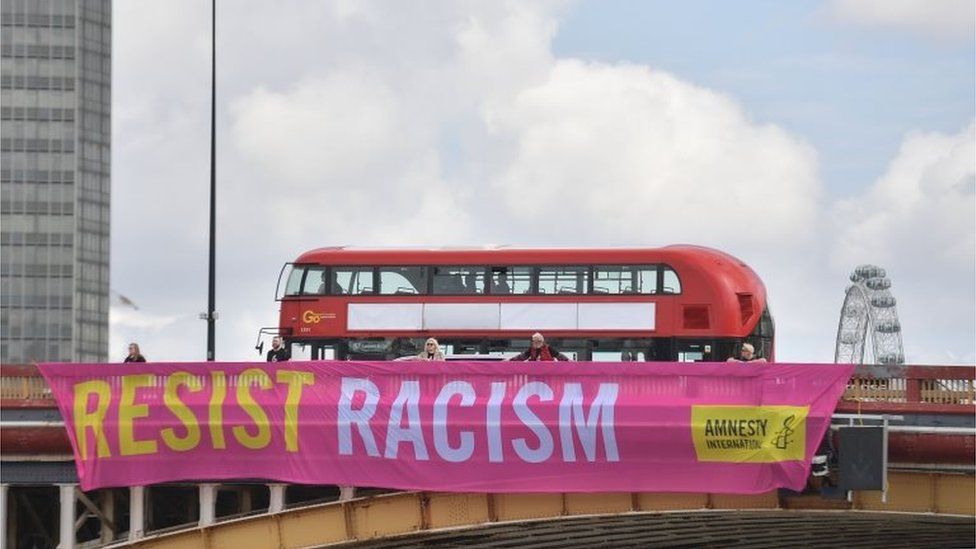 A banner saying Resist racism on Vauxhall Bridge, London