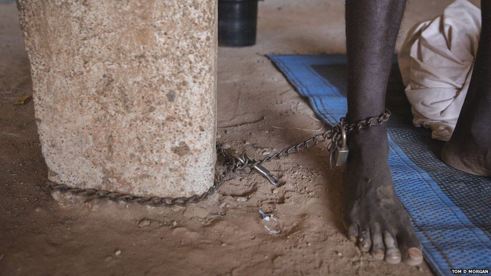 A man chained to a tree