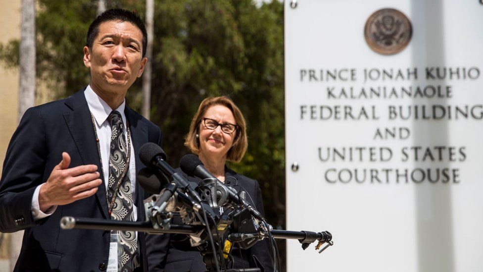 Hawaii State Attorney General Douglas Chin speaks as Oregon Attorney General Ellen Rosenblum looks on at a press conference in front of the Prince Jonah Kuhio Federal Building and US District Courthouse on March 15, 2017 in Honolulu, Hawaii