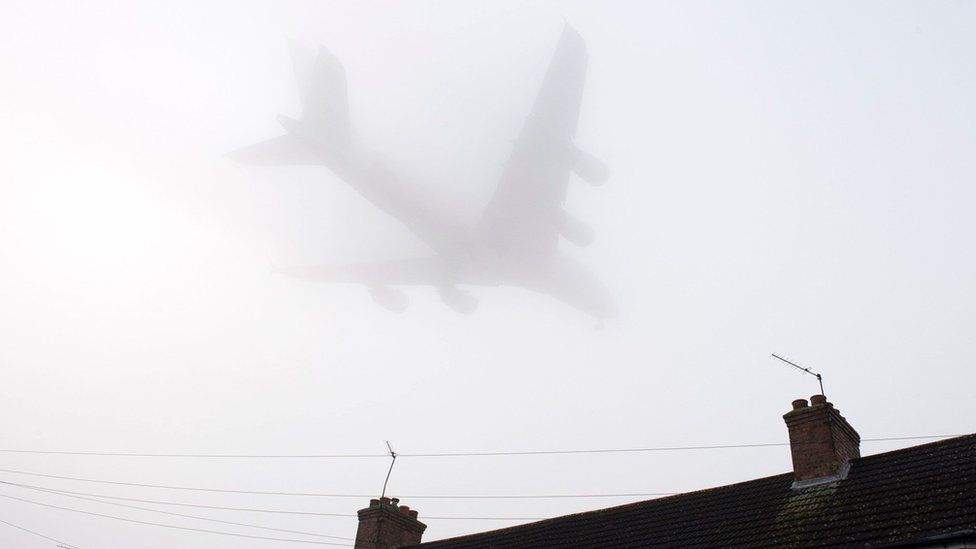 Plane landing at Heathrow in fog