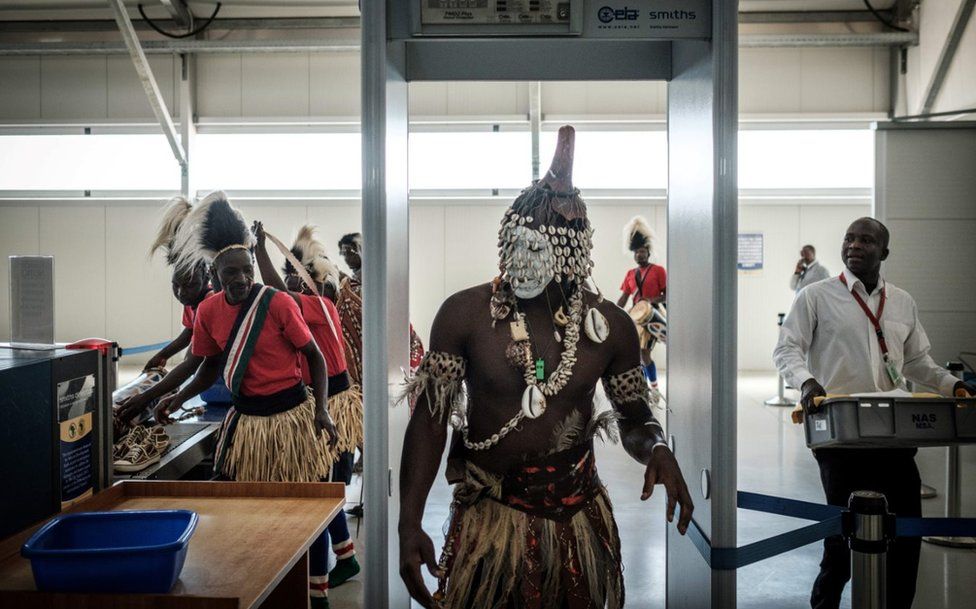 A dancer passes through a security checkpoint at the Jomo Kenyatta International airport on February 26, 2018 in Nairobi, prior to the arrival of the FIFA World Cup Trophy during its World Tou