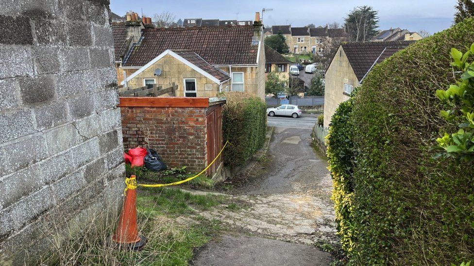 A police cordon in place between Coronation Avenue and Ivy Avenue in Bath. The yellow police tape can be seen on the left and houses can be seen in the distance.
