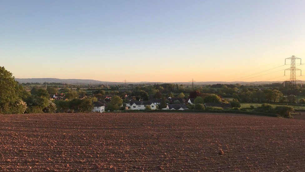 A view from a field of the village of North Fitzwarren at dusk