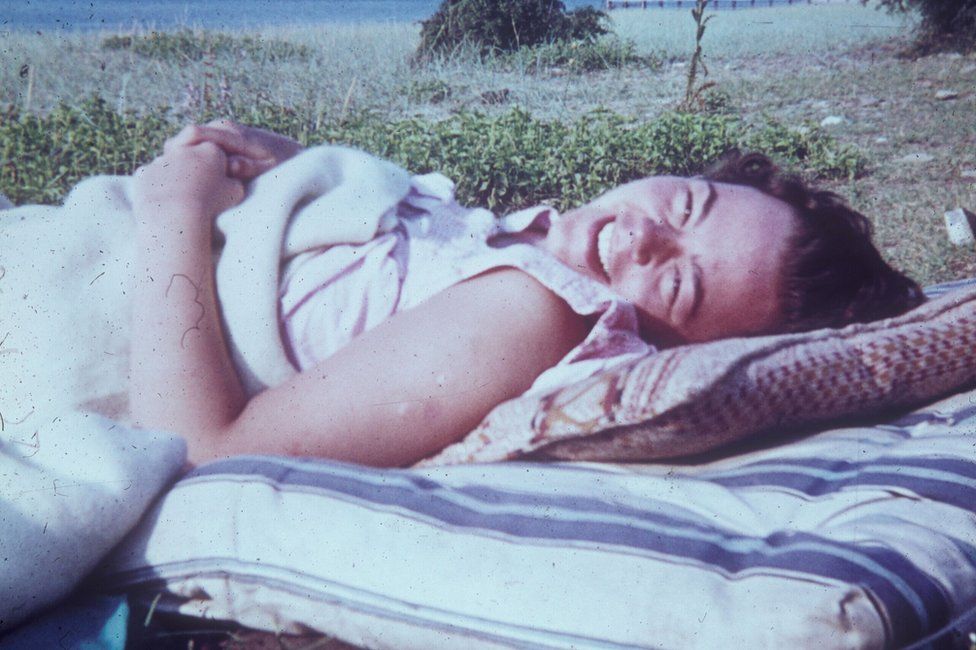 Wendy Scott lying on a mattress on the beach by the Black Sea
