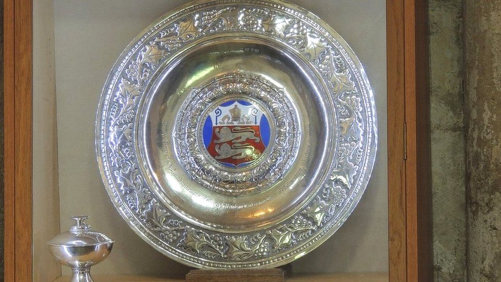 Decorative large silver plate and cup, with the plate having an enamel coat of arms in the middle