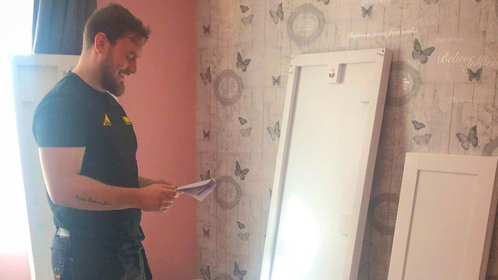A man helping to renovate a bedroom