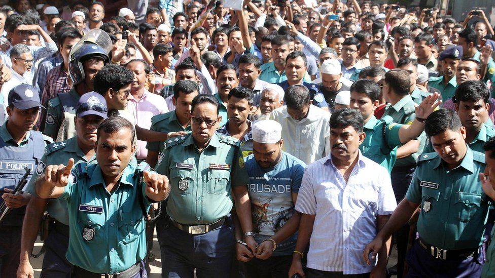 Police escort one of the accused to the courtroom in Sylhet - 8 November