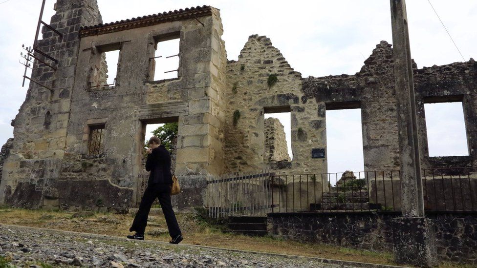 A visitor walks past the remains the French martyr village of Oradour-sur-Glane, near Limoges, 6 August 2013