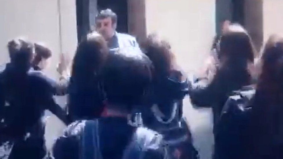 Screengrab of a video showing protesting girls forcing a man believed to be a local education official to leave their school in Karaj, Iran (3 October 2022)