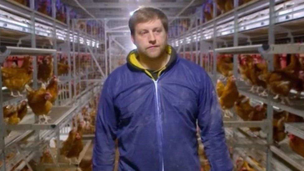 Shows poultry farmer Llyr Jones at his farm in North Wales