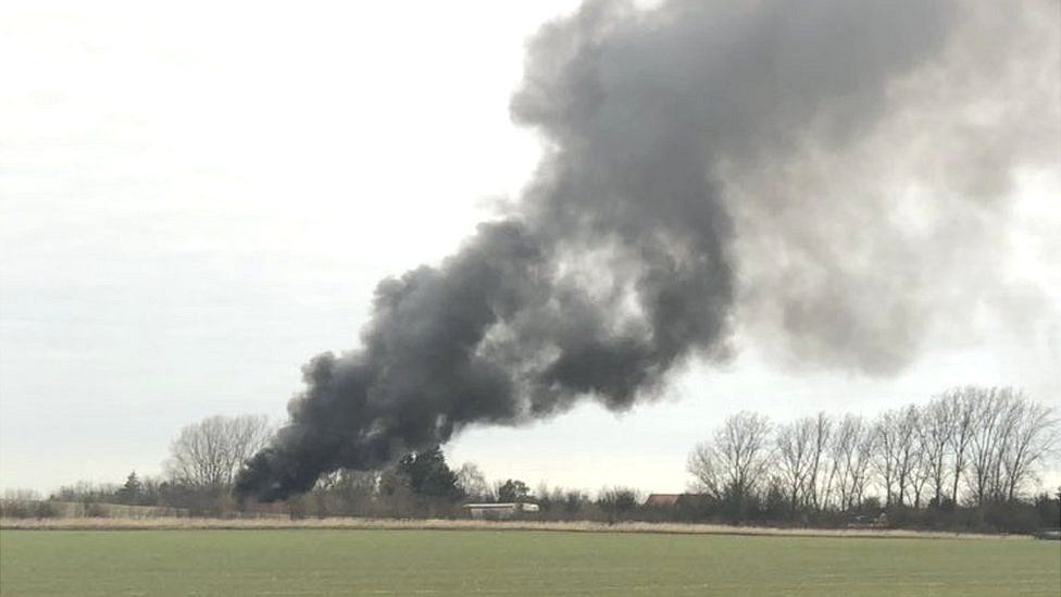 The HGV fire, south of Huntingdon in Cambridgeshire, has created a large plume of black smoke.