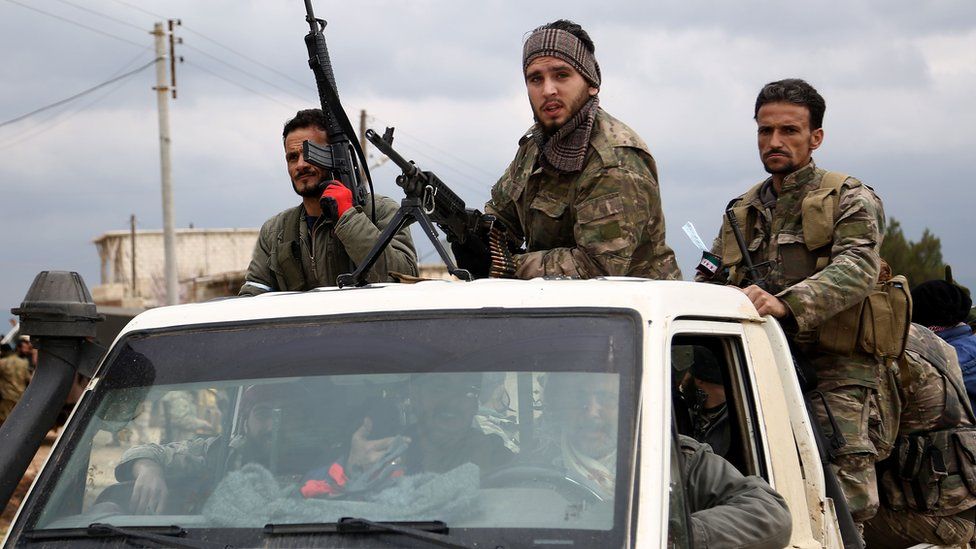 Turkish-backed Syrian rebel fighters stand in a vehicle as they fight Kurdish forces in Afrin (21 February 2018)