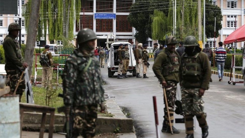 Indian paramilitary soldiers of Central Reserve Police Force (CRPF) stand guard near the main gate of the National Institute of Technology (NIT) in Srinagar,