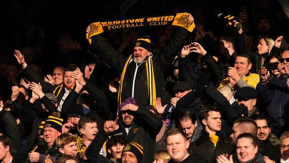 Maidstone United fans celebrating the full-time win at Ipswich Town