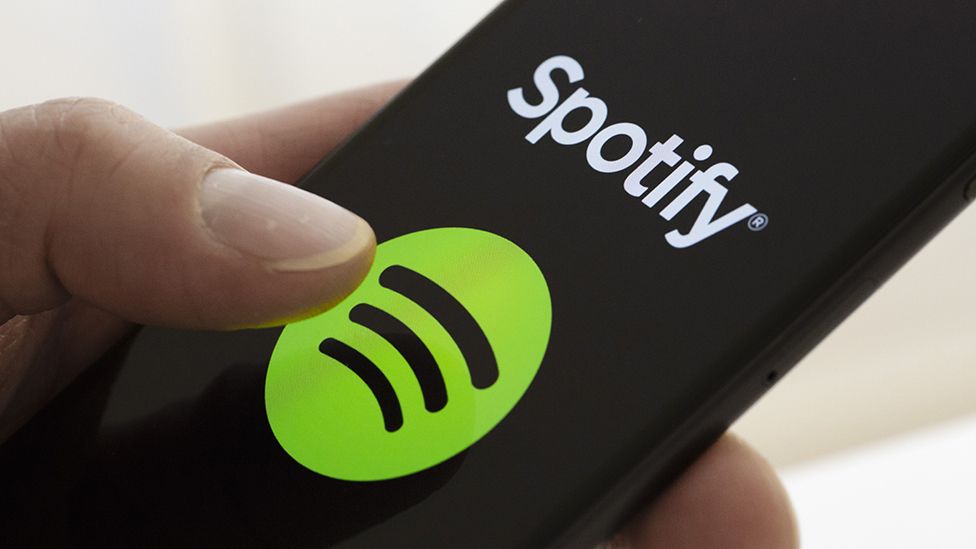 Spotify logo seen on smartphone as someone uses it