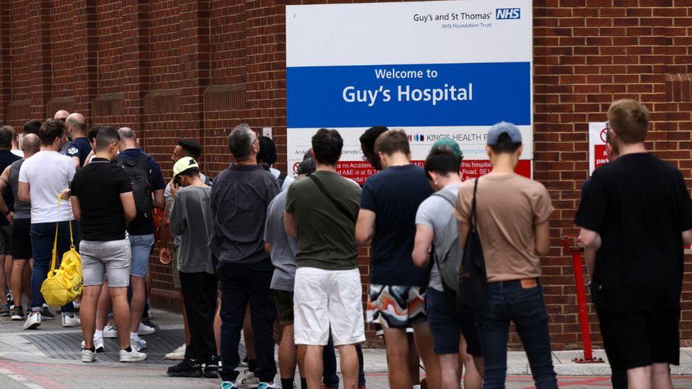 People queue up to receive monkeypox vaccinations during a pop-up clinic at Guy's Hospital