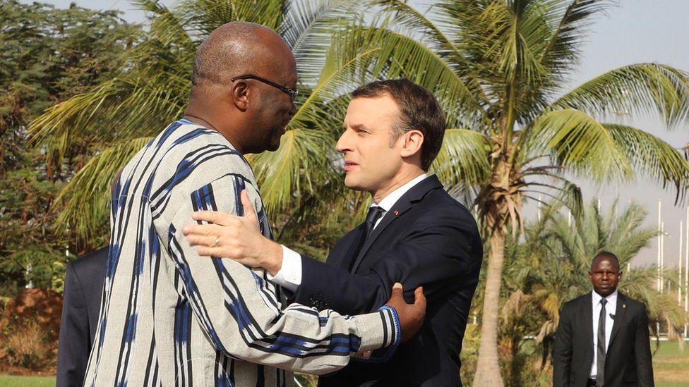 France's President Emmanuel Macron embracing Burkina Faso's president Roch Marc Christian Kabore