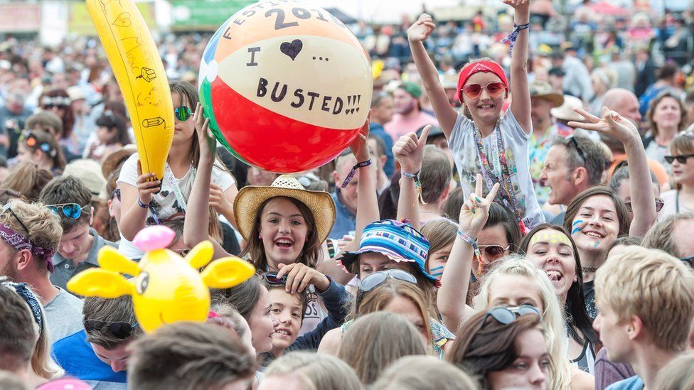 Festival goers watch Busted on the main stage