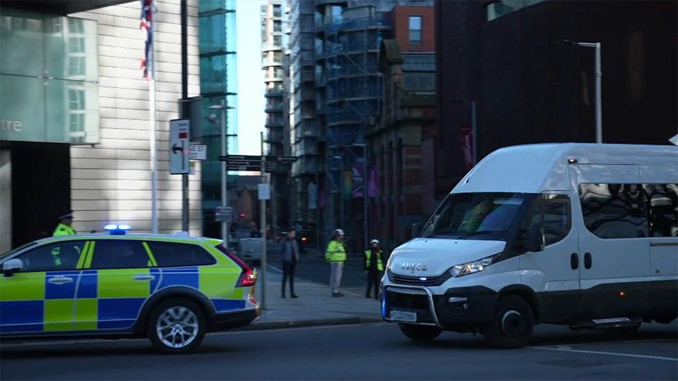 Police escorted a van into Manchester Crown Court