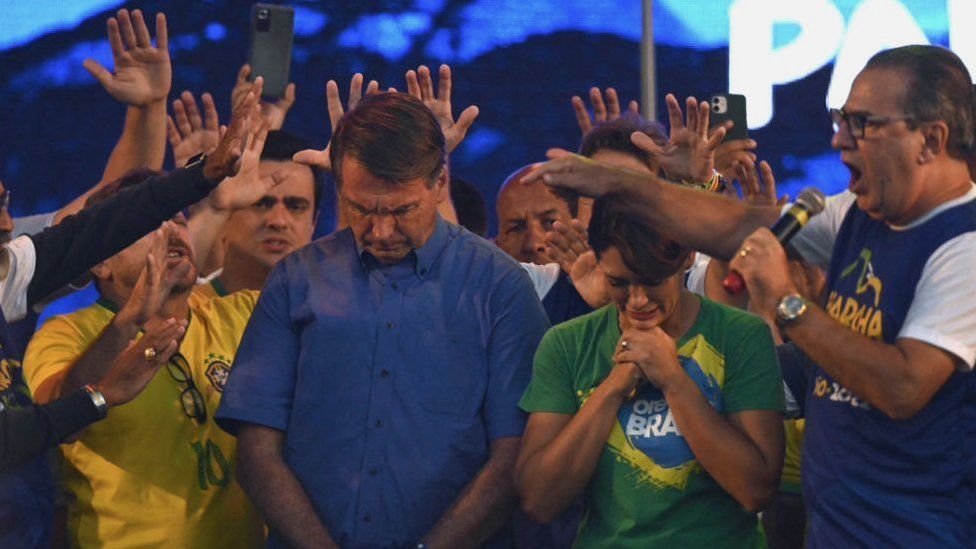 Evangelical Minister Silas Malafaia (R) and other evangelical leaders pray around Brazilian President Jair Bolsonaro