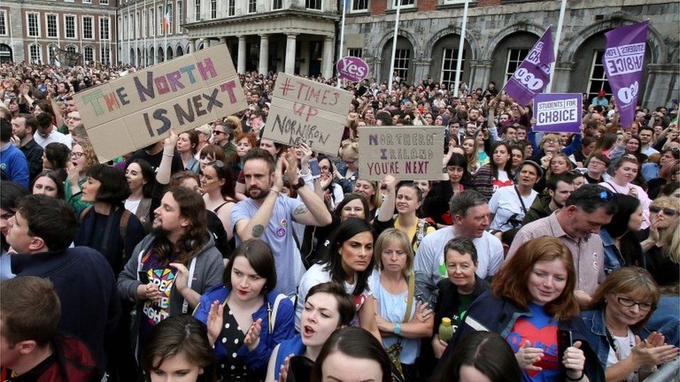 Pro-choice campaigners hold up signs calling for the liberalisation of abortion laws in Northern Ireland