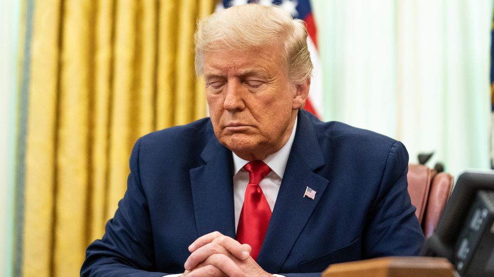 US President Donald Trump participates in a prayer during an event in the Oval Office of the White House - 28 August 2020