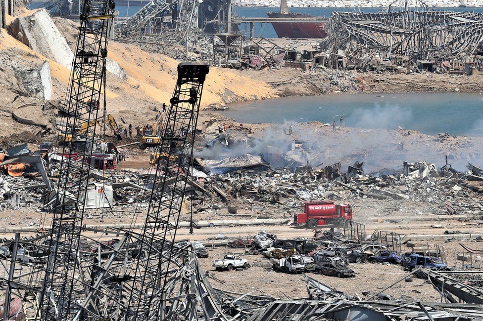 Lebanese rescue workers work near the site of an explosion at Beirut's port (5 August 2020)