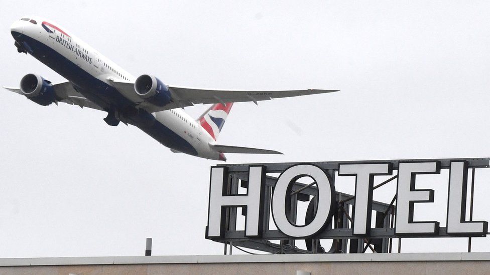 A plane flies over a hotel near Heathrow Airport near London