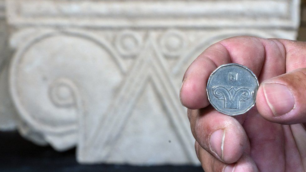 Five shekel coin against the background of the capital discovered