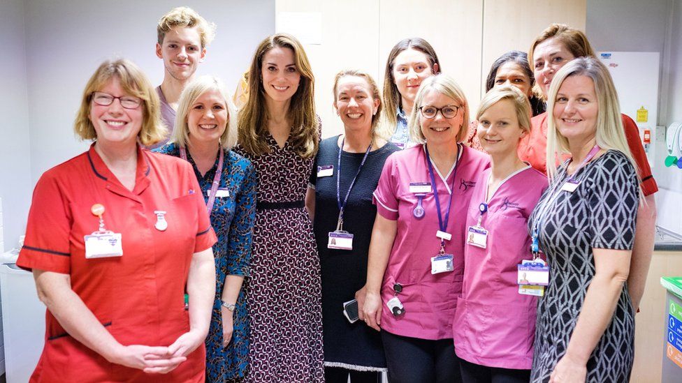 Kate poses with staff at the maternity unit in Kingston Hospital