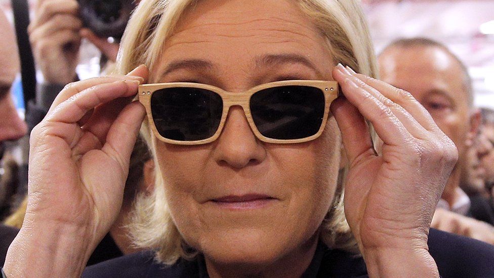 French far-right leader Marine Le Pen tries on glasses in Paris, 18 November 2016