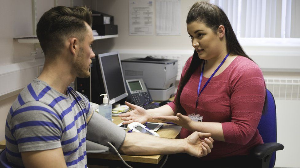 Patient having blood pressure taken