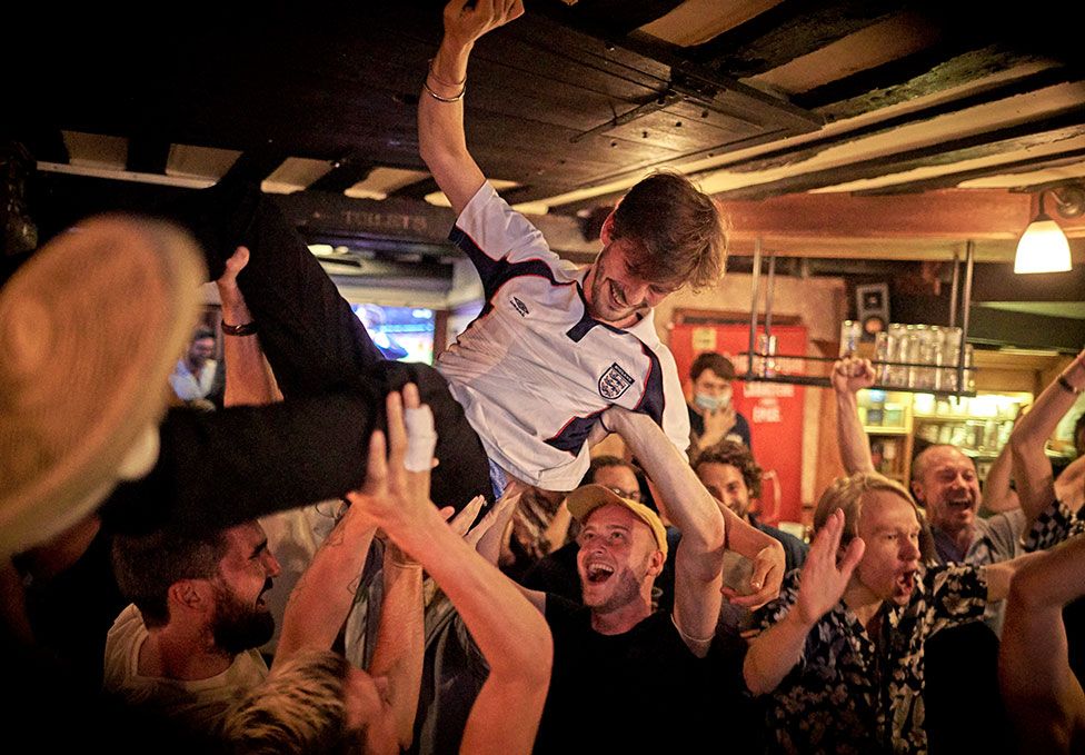 England fans celebrate in the Bombardier English Pub in Paris as England beat Denmark to reach the final of the European Football Championship
