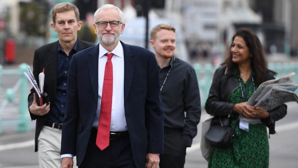 Jeremy Corbyn with aides including Andrew Fisher