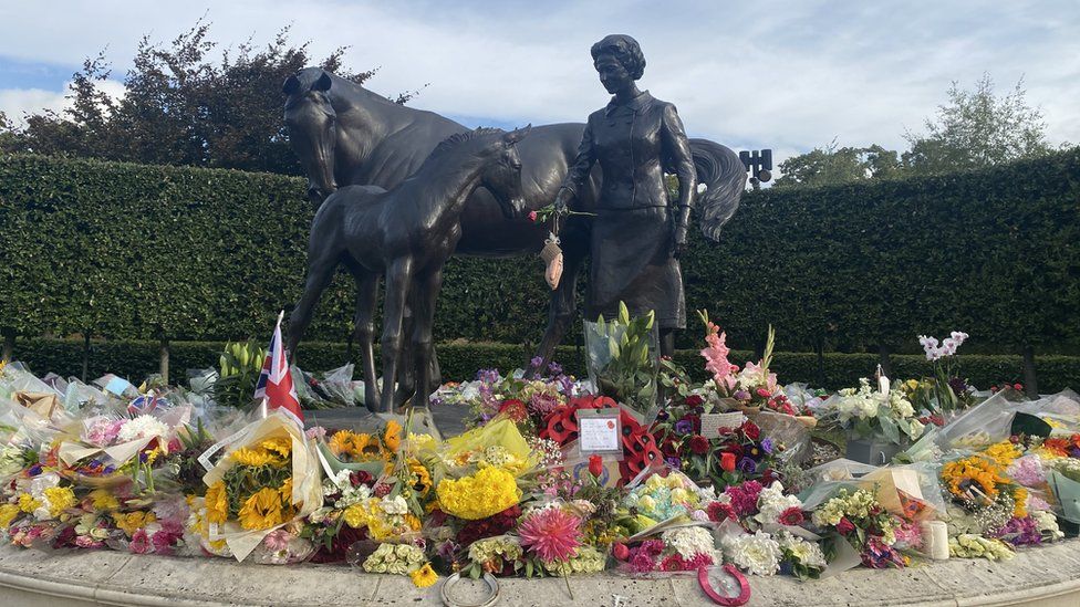 Flowers at the statue of the Queen in Newmarket