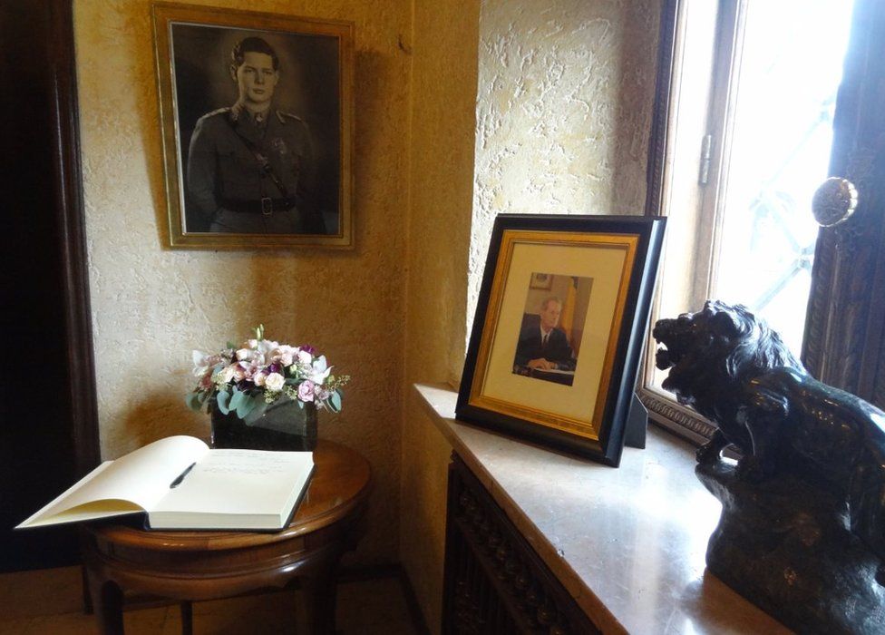 A book of condolences lies beneath a portrait of the king at Bucharest's Elisabeta Palace