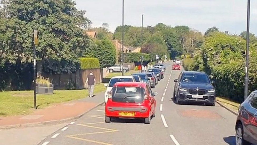 Cars blocking yellow school road markings
