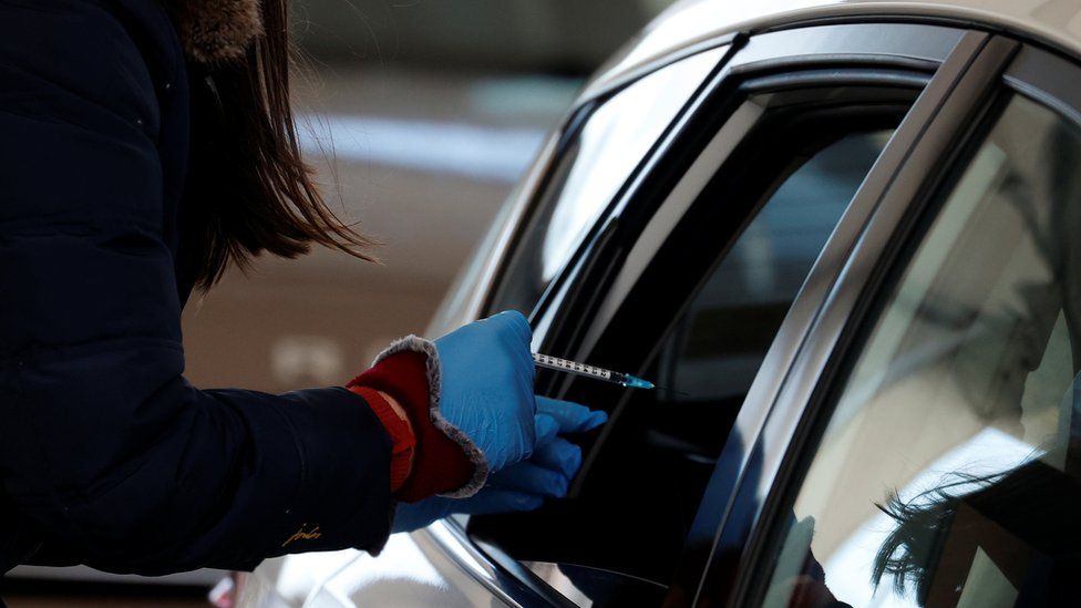 A nurse prepares to give the Pfizer-BioNTech COVID-19 vaccine at a drive through vaccination centre amid the outbreak of the coronavirus disease (COVID-19) in Hyde, Britain