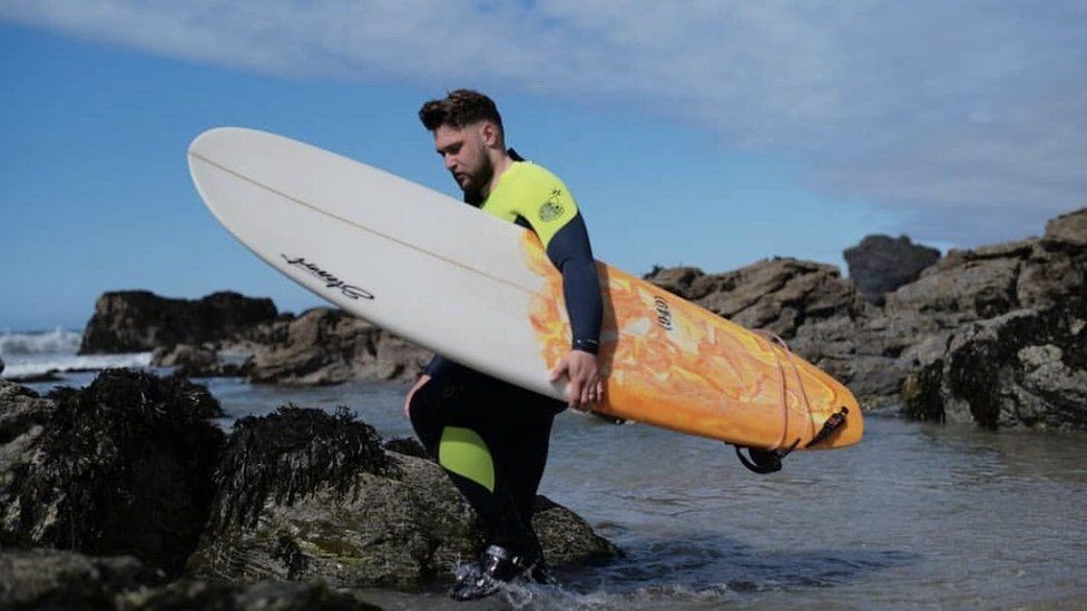 Ryan O'Carroll with surf board