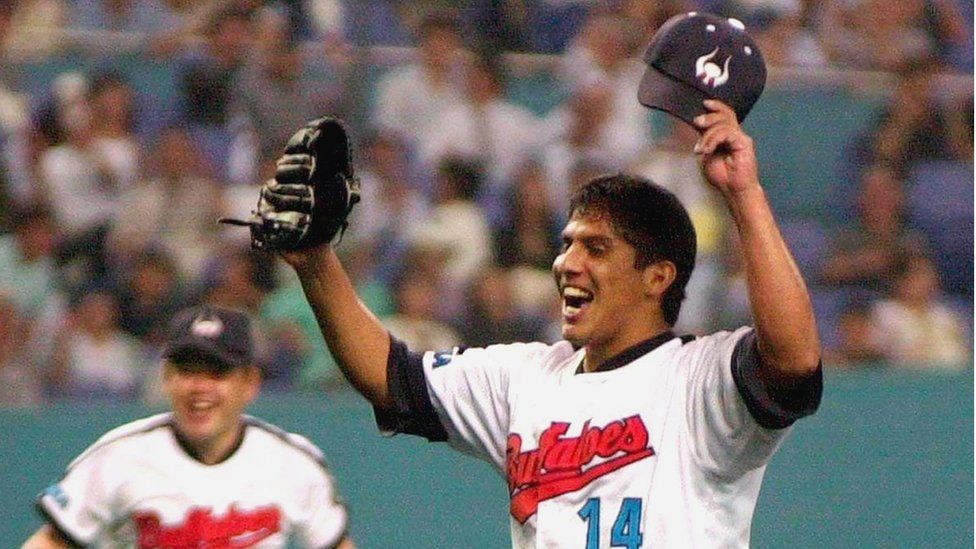 Mexican pitcher Narciso Elvira of the Kintetsu Buffaloes throws his hands in the air to celebrate after he pitched a no-hit, no run game against the Seibu Lions during a Pacific League professional baseball game at the Osaka Dome, in western Japan 20 June 2000