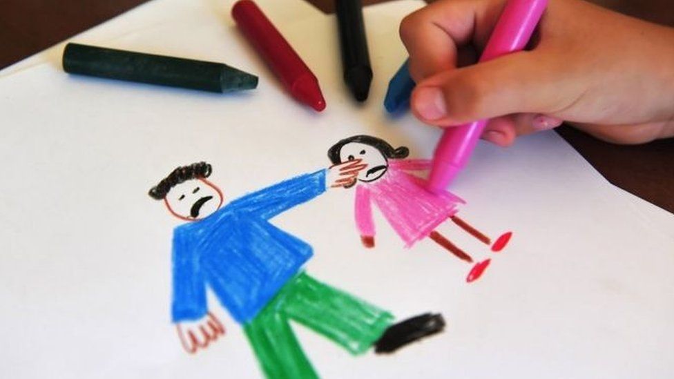 Child drawing an image of domestic abuse